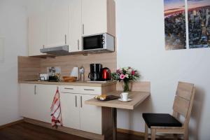 Кухня или мини-кухня в Das Falk Apartmenthaus

