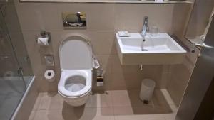a bathroom with a toilet and a sink at Airport Hotel Golden Bliss Near Delhi Airport in New Delhi