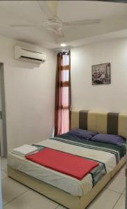 a bed in a room with a window at Central residence in Kuala Lumpur