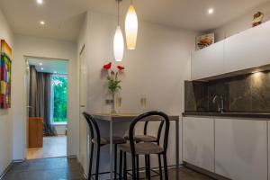 a kitchen with two chairs and a table in a room at Rinkus in Saulkrasti