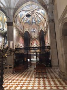 a church with a large ceiling and a room with chairs at Pensione Delfino Azzurro in Loreto
