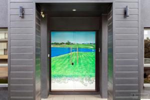 a door with a picture of a golf course on it at 4CHP The Sands in Torquay