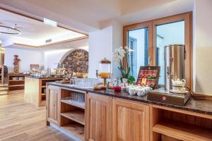 a kitchen with a counter with some food on it at Hotel Goldener Stern in Abtenau