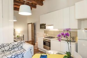 a kitchen and living room with a couch and a table at Borgo dei Salinari Apartments in Cervia +33 photos