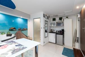 a kitchen and living room with a view of the ocean at Jacuzzi Apartment Zen in Kraków