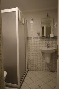 a bathroom with a shower and a sink at Artemis Hotel in Bodrum City