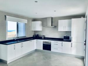 A kitchen or kitchenette at Casa Achaman - Contemporary style villa with outstanding views