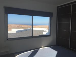 A bed or beds in a room at Casa Achaman - Contemporary style villa with outstanding views