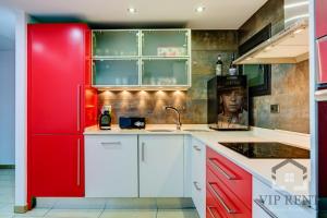 a kitchen with red cabinets and a red refrigerator at Borda Candia,jacuzzi ,Parking in Encamp