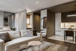 a living room with a white couch and a kitchen at Classy Studio in Chicago, a Luxurious Condo in Kyiv
