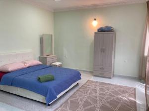 a bedroom with a bed and a dresser in it at Hanna Homestay Kangar in Kangar