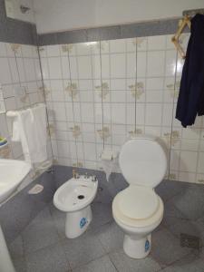 a bathroom with a toilet and a sink at casa lucy in Puerto Iguazú +16 photos