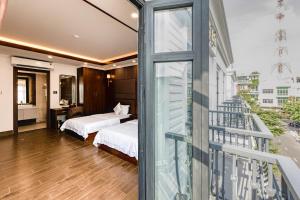 Postel nebo postele na pokoji v ubytování Hotel Trí Lê