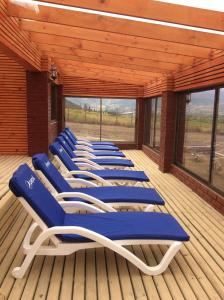 a row of blue lounge chairs on a deck at San José Hotel Boutique & Spa in La Ligua