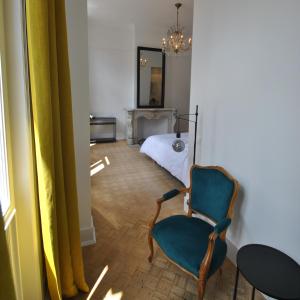 a living room with a chair and a bed at Upstairs in Antwerp