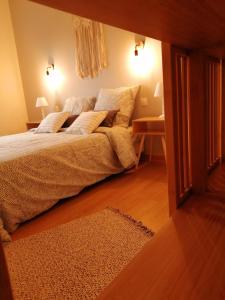 a bedroom with a large bed with pillows on it at Villa bord de mer avec piscine et jacuzzi in Pénestin