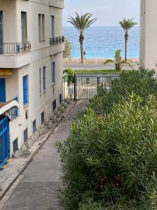 a building with the ocean in the background at Cozy studio with a sea view in Nice
