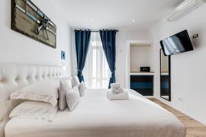 Postel nebo postele na pokoji v ubytování Ripetta Central Suites