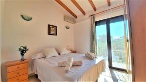 a bedroom with a bed with towels on it at Villa Costa in Moraira +22 photos