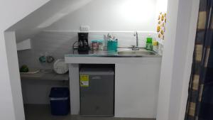 una pequeña cocina con fregadero y encimera en Habitación Privada 10 min de la playa, entrada independiente., en Santa Marta