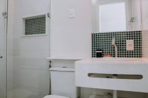 a bathroom with a sink and a toilet at Casa beira mar na Praia da Redinha by Qavi in Natal