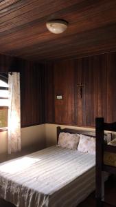 Ένα ή περισσότερα κρεβάτια σε δωμάτιο στο Hospede-se a 2 minutos da Praia em Bertioga