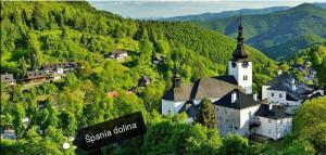 a small village with a church on a mountain at Apartmán pre 5 osôb, 2 spálne, Banská Bystrica Podlavice 24h self checkin in Banská Bystrica