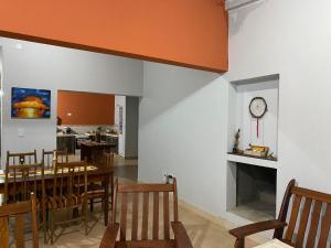 comedor con mesa y reloj en la pared en Casa de Campo Vertientes en Cafayate
