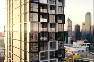 een weergave van een hoog gebouw met ramen bij Mega Style Apartments The International in Melbourne