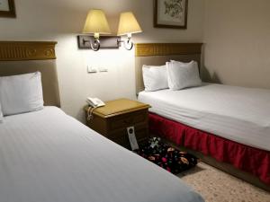 Postel nebo postele na pokoji v ubytování Hotel Olmeca Plaza