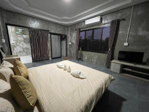 楠府的住宿－Hugpua Hotel，一间卧室配有带3个枕头的床