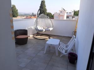 a balcony with a hammock chair and a swing at Nice suite Nahariyya in Nahariyya