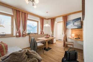 a living room with a table and a dining room at Alpenkönig in Zell am Ziller