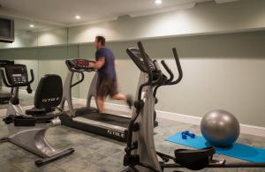 a man running on a treadmill in a gym at Saratoga Arms in Saratoga Springs