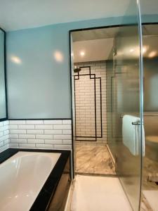 a bathroom with a tub and a glass shower at InterContinental Marine Drive Mumbai, an IHG Hotel in Mumbai