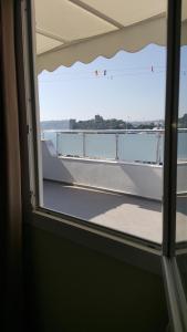 an open window with a view of a balcony at Artemis Hotel in Bodrum City