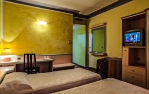 Postel nebo postele na pokoji v ubytování Hotel Grazia Deledda