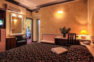 Postel nebo postele na pokoji v ubytování Hotel Grazia Deledda