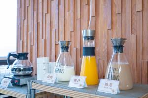 a table with two bottles of orange juice on it at Skylight bnb in Yuchi