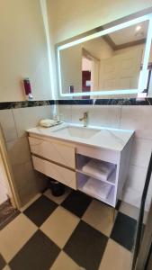 a bathroom with a sink and a mirror at LilyPark Lodge in Rustenburg