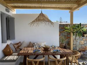 een tafel en stoelen op een patio bij Villa Ypsilon Naxos - luxury holiday house with amazing sea view & private pool in Agia Anna Naxos