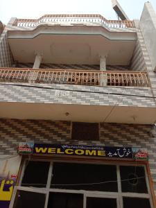 a welcome sign on the side of a building at NTP Hotel in Lahore