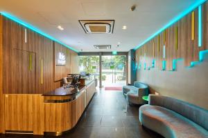 a waiting room with blue lights on the wall at ibis budget Singapore Bugis in Singapore