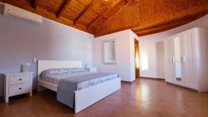 1 dormitorio con cama y techo de madera en Casa las Estrellas, en Agua de Bueyes
