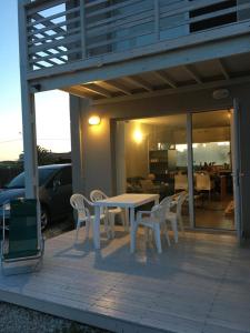 a patio with a table and chairs on a deck at AYRES DEL MAR de Cobo in Mar de Cobo