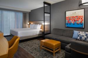 a living room filled with furniture and a tv at Hyatt Place Boston/Seaport District in Boston