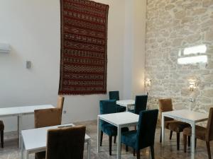 a room with tables and chairs and a wall with a flag at Casa City Break Appart hôtel in Casablanca