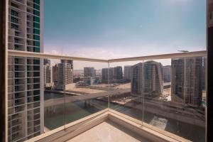 a view of a city from a balcony in a building at Luton Vacation Homes - Damac Maison Prive Studio, Canal View, Dubai - 16AB03 in Dubai