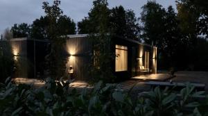 dom z oświetloną fasadą w nocy w obiekcie Mooiverblijf w mieście Oosterwolde