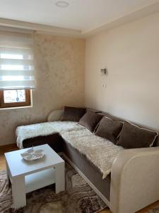 a living room with a couch and a table at Apartmani Ristanović in Zlatibor +15 photos